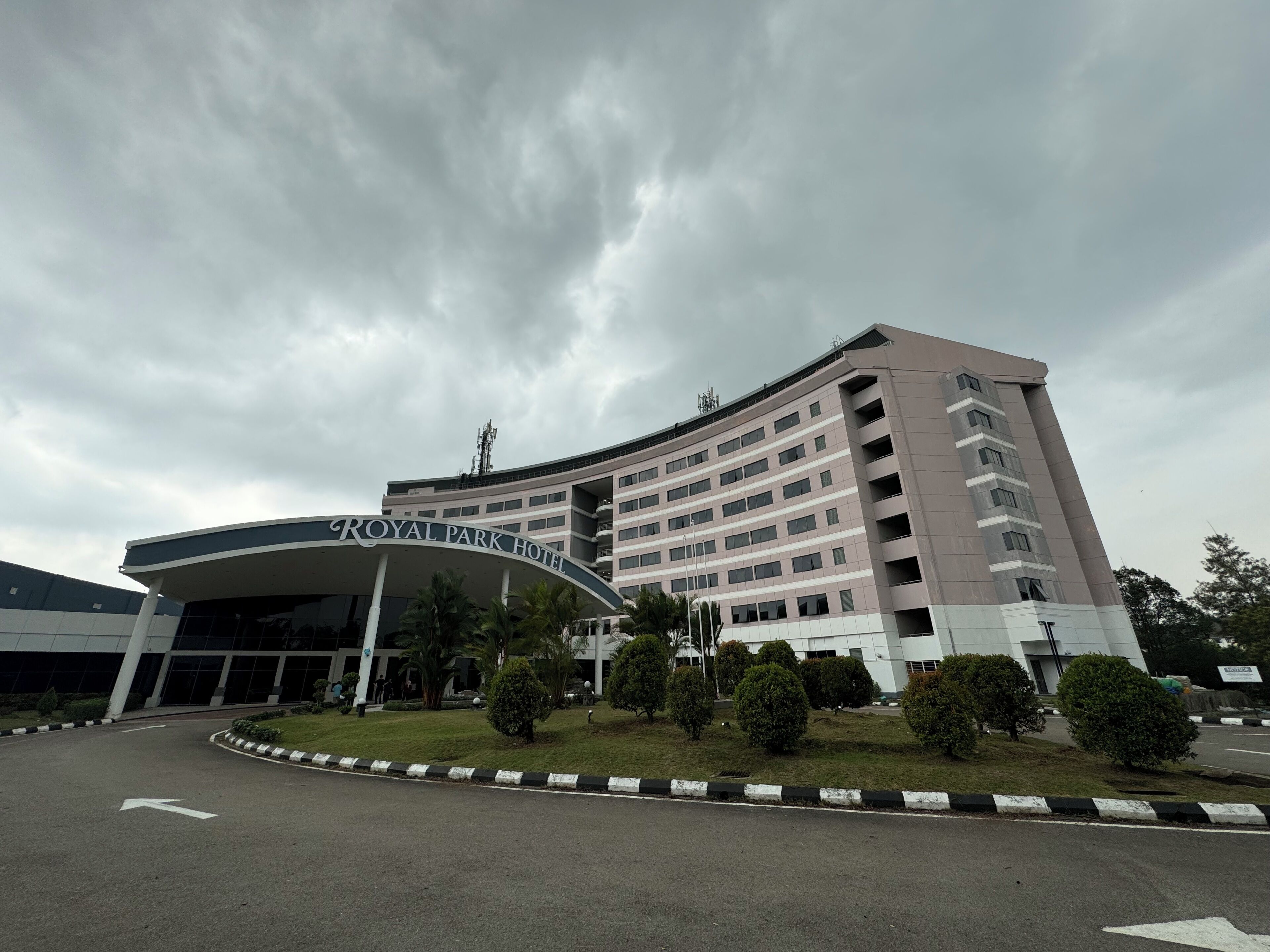 A multi-story hotel with a curved entrance and a sign reading "ROYAL PARK HOTEL".