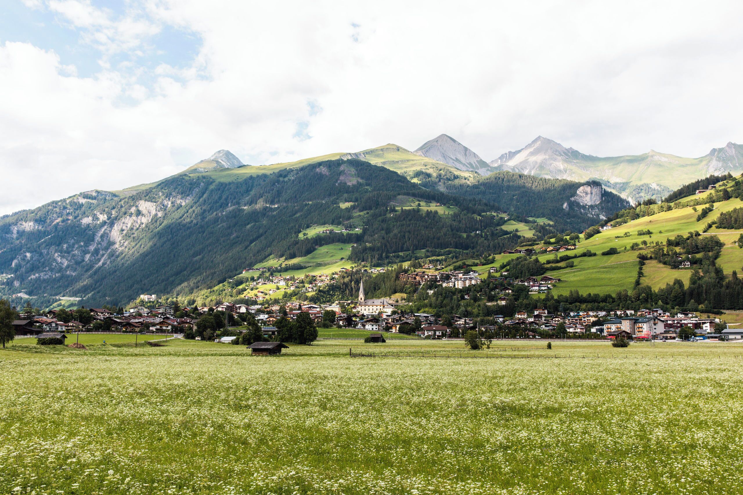 A mountainous landscape with a village nestled in the valley.