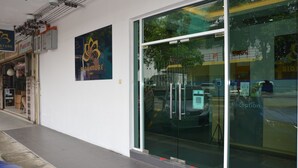 A building with a reception area, glass doors, and a sign for 'Signature'. - Signature Inn (Kota Kinabalu)