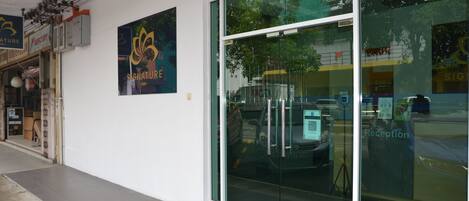 A building with a reception area, glass doors, and a sign for 'Signature'.