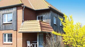 A two-story house with a covered porch and a brick facade. - Apartment in Petersdorf for 6 Personen (Petersdorf)