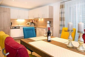 Enjoy dining and socializing in this well-appointed room with a dining table, comfortable seating area, and fully equipped kitchen.