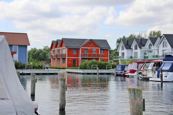 Waterfront homes with pitched roofs and docks.