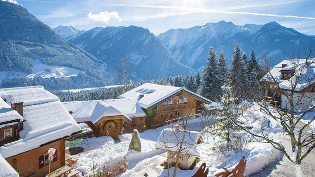 A snow-covered mountain village with wooden houses and a clear view of the surrounding peaks. - Chalet in Wildkogel near Ski Slopes (Neukirchen)