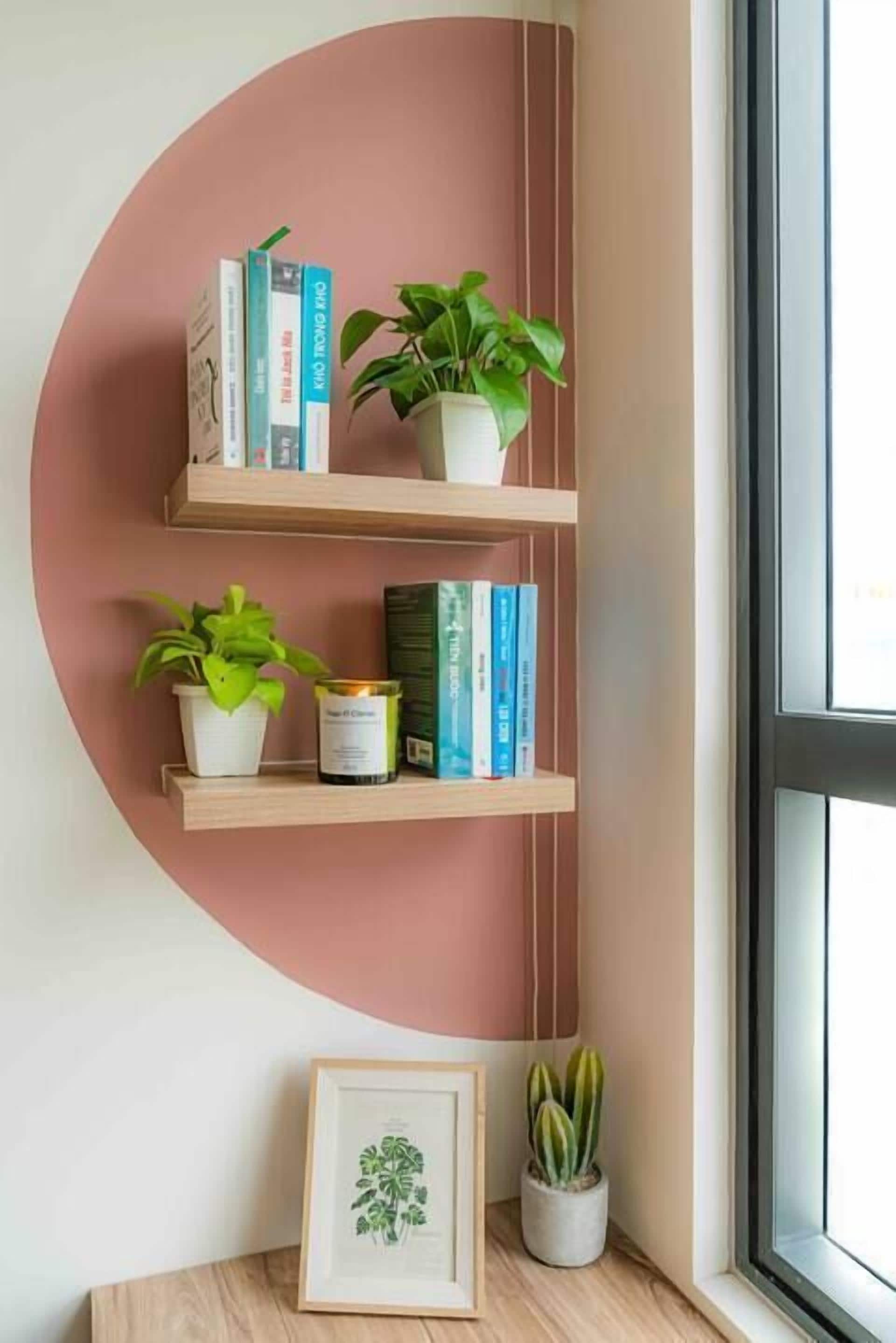 A wall-mounted shelf with books and potted plants.