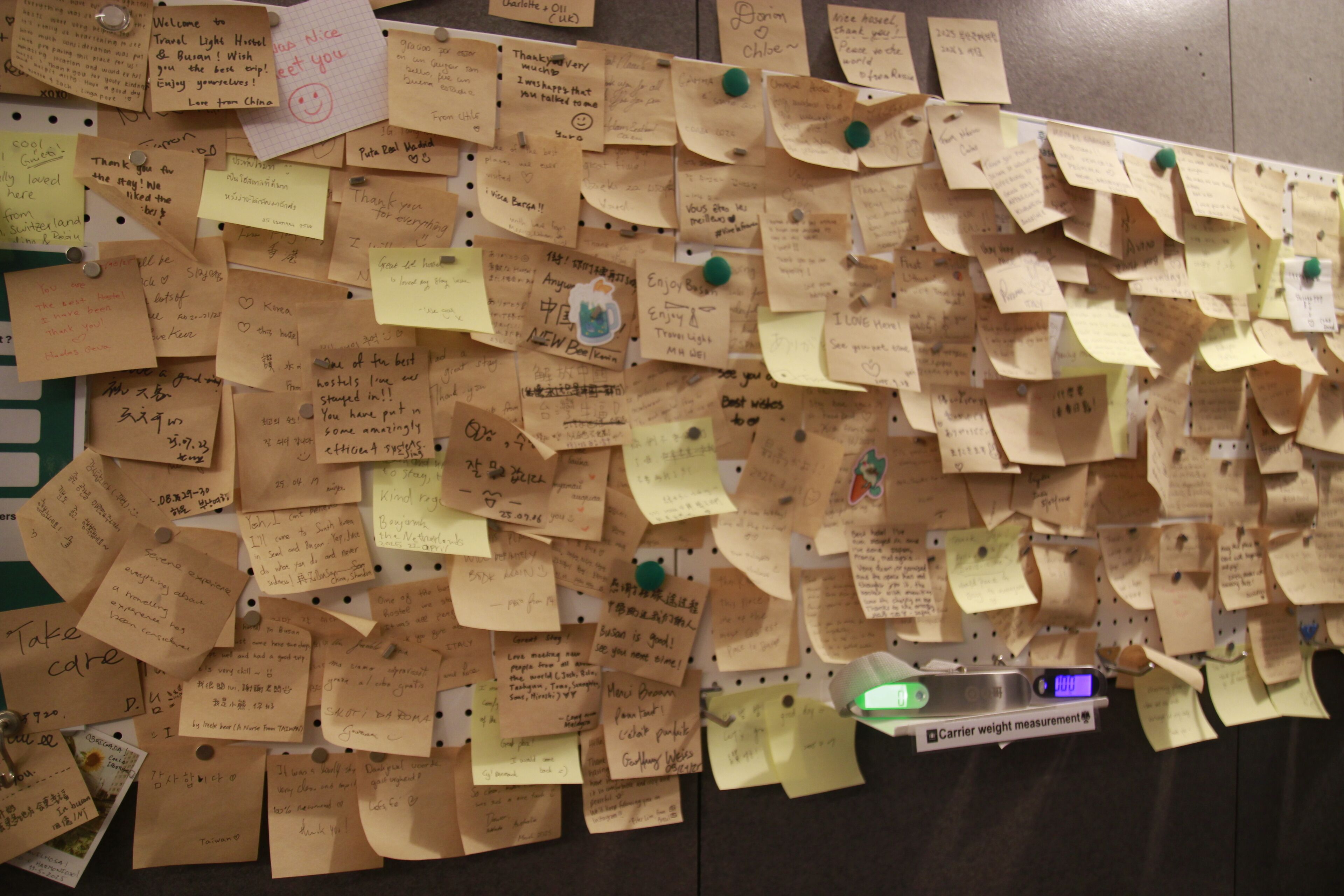 A wall covered with numerous handwritten notes and messages pinned to it.