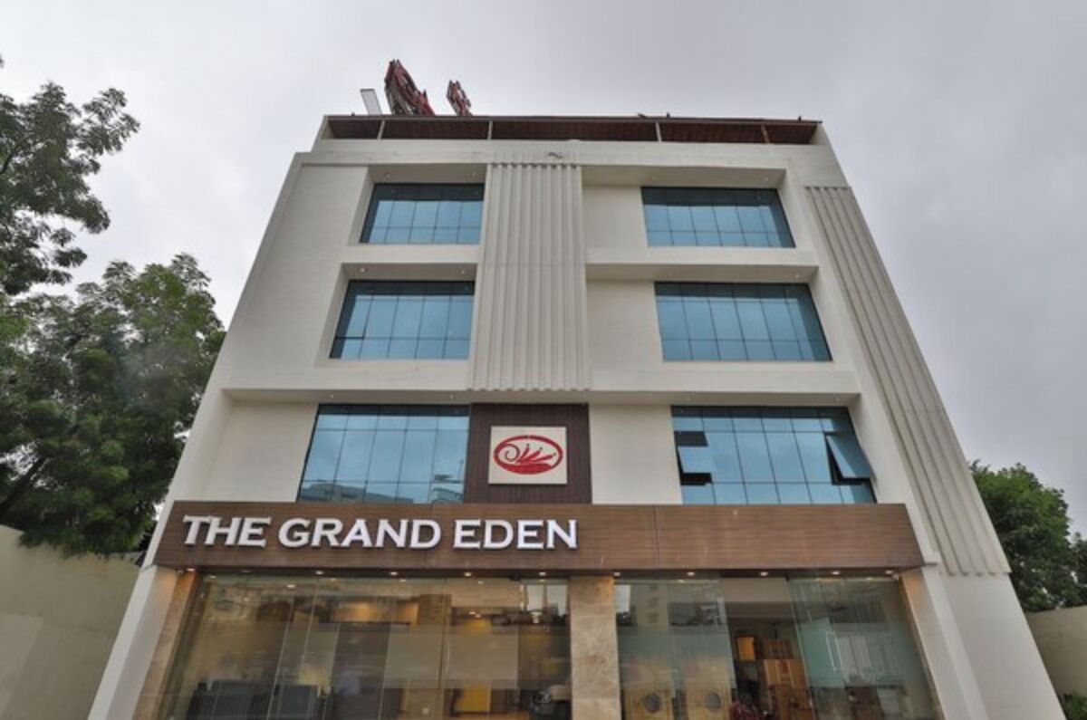 A building with a sign reading "THE GRAND EDEN" and a logo above the entrance.