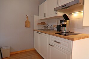 Fridge, stovetop, coffee/tea maker, dining tables