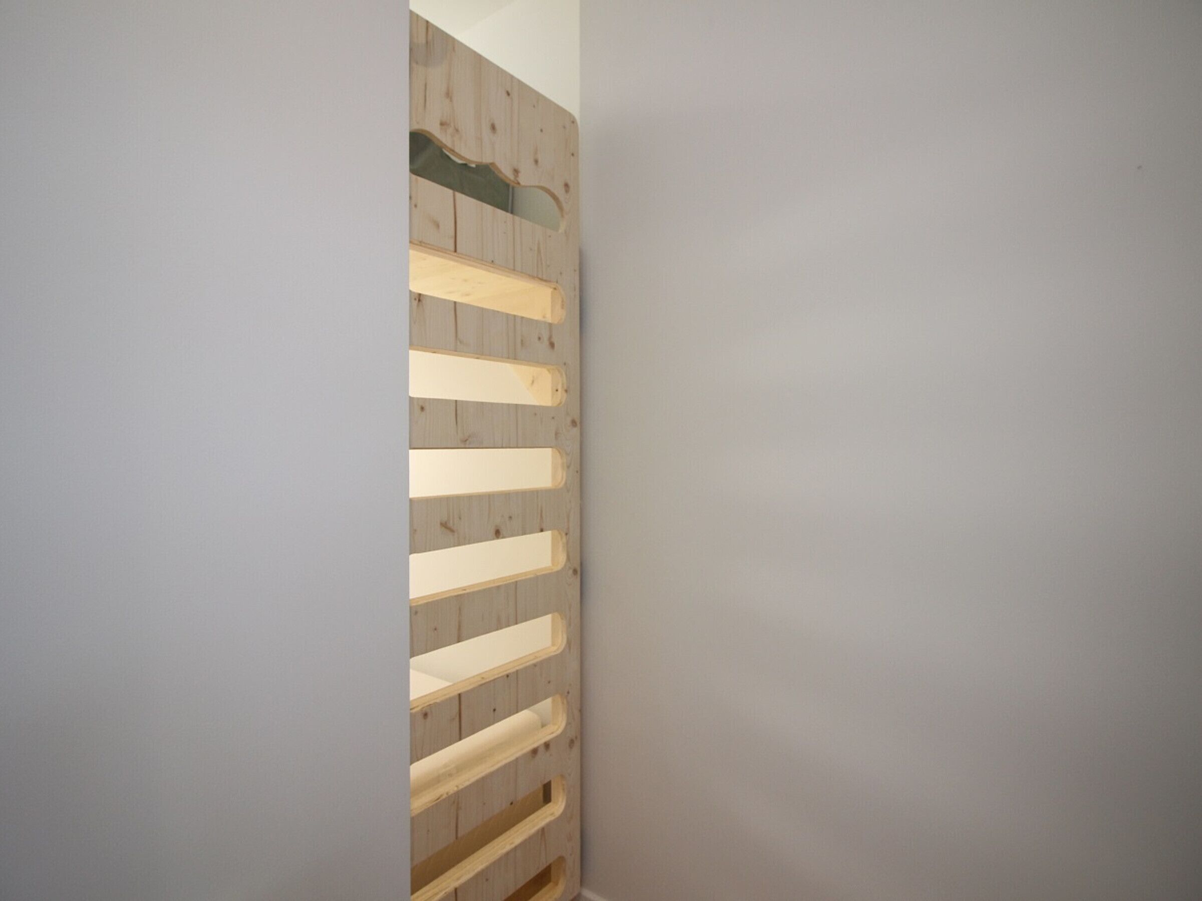 A corner of a room with a wooden slat wall design.