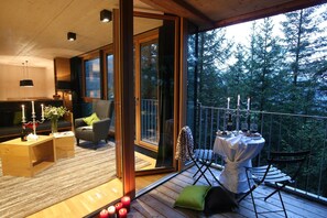A cozy living area with a sofa, a coffee table, and a dining table set for two.