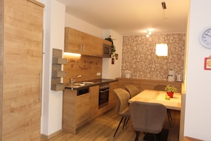 Enjoy cooking in the well-equipped kitchen with an oven, dining area, and ample space for meals.