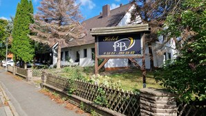 A hotel with a signboard displaying the name and contact number. - PB Hotel Pension (Goslar)