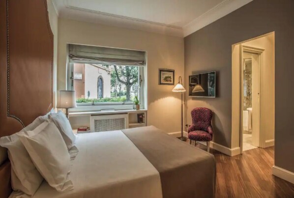 A hotel room with a bed, a chair, a window, and a door. -
Luxurious Apartment Overlooking the Colosseum (Roma)