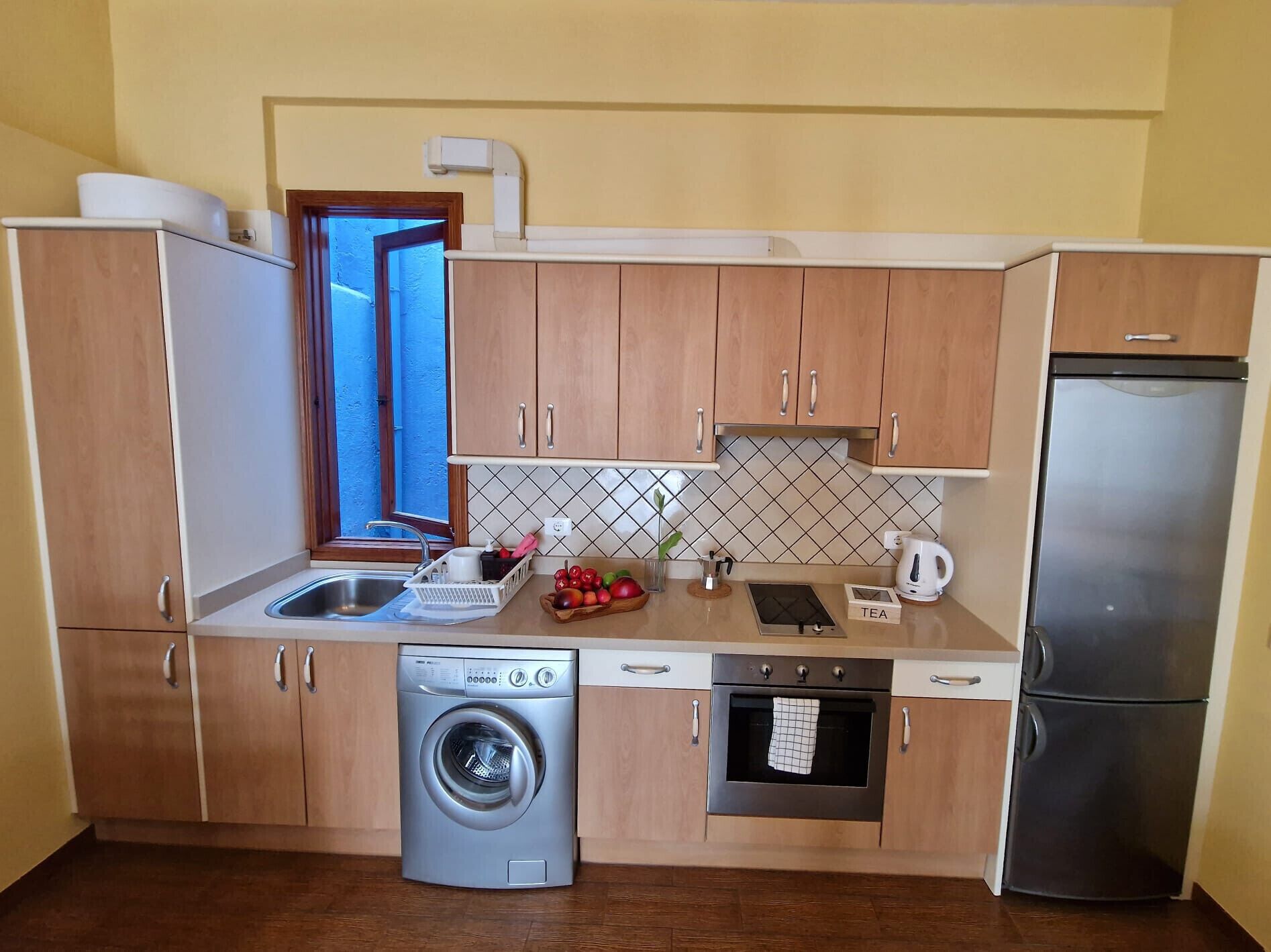 Een koelkast, een oven, een koffiezetapparaat/waterkoker, een waterkoker