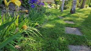 A garden pathway leading to a house with a stone wall and lush greenery. - Villa Markiza - Summer House by the River, at the National Park Central Balkan   (Kalofer)