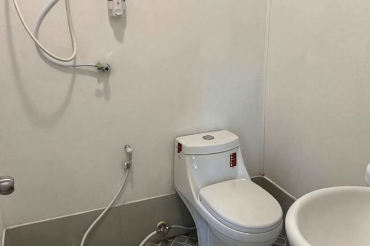 A bathroom with a toilet, a sink, and a shower.