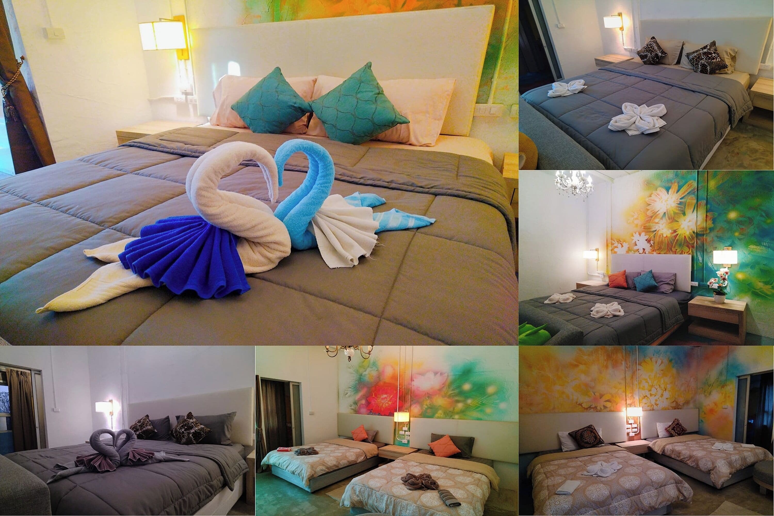 A hotel room with a large bed, two smaller beds, and a painting on the wall.