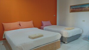 A room with two beds, each with a pillow and a folded towel. - Review Resort (Sattahip)