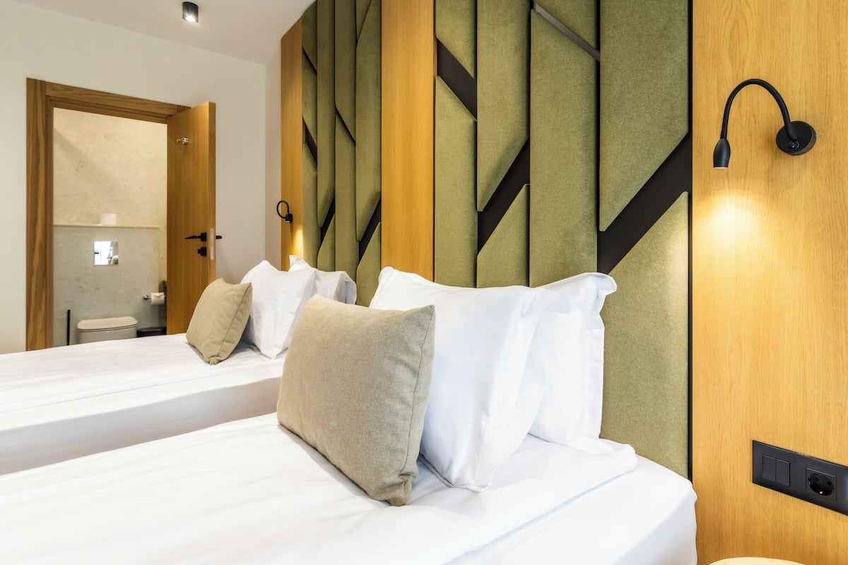 Family Quadruple Room, Balcony | In-room safe, laptop workspace, blackout curtains