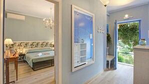 A bedroom with a bed, a nightstand, a desk, and a chair. There is a window with a view of greenery outside. - Pinehome & Garden - Total Relax (Borghetto Santo Spirito)