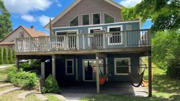 A two-story house with a balcony and a hammock. - Elberta Bluffs Cottage (Elberta)