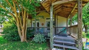 A wooden porch with a railing, steps leading up to a door, and a mailbox. - SLW504A: Gone Coastal-Adorable 2 bed, 2 bath Unit Few Blocks from the Beach (Carolina Beach)