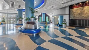 A spacious lobby with a checkered floor, large blue and silver columns, and a decorative wall with a relief sculpture. - ☀️Ocean Front Condo with Expansive Views-Daytona Ocean Walk Resort 1707☀️ (Daytona Beach)