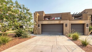 A modern building with a flat roof, two garage doors, and a paved driveway. - Luxe 4BR w/ Canyon Views - 3 King Beds & Hot Tub (St. George)