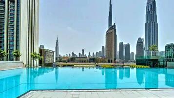A rooftop pool with a city skyline in the background.