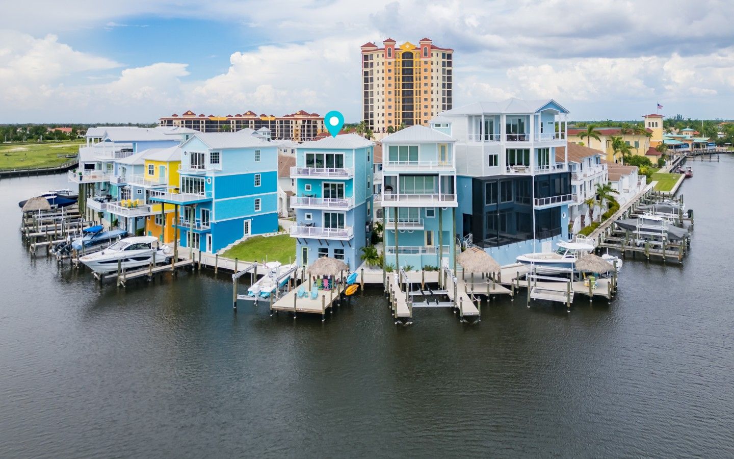A waterfront property with multiple buildings, docks, and boats.
