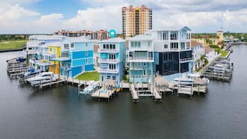 A waterfront property with multiple buildings, docks, and boats.