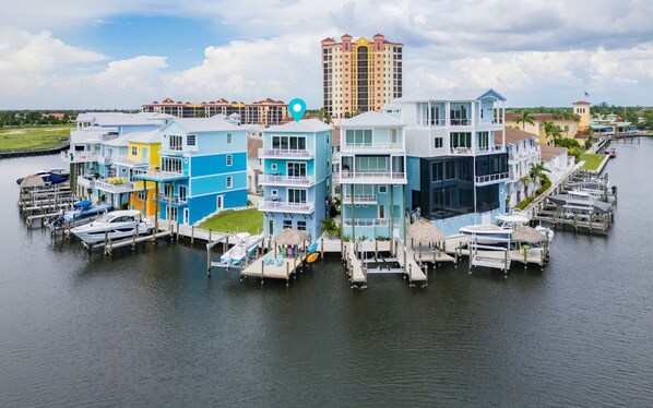 A waterfront property with multiple buildings, docks, and boats.