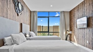 A hotel room with a large bed, a TV, and a window with curtains. - Last Minute Disney Getaway! Luxury Villa with Private Pool. Book Now! #66003 (Orlando)