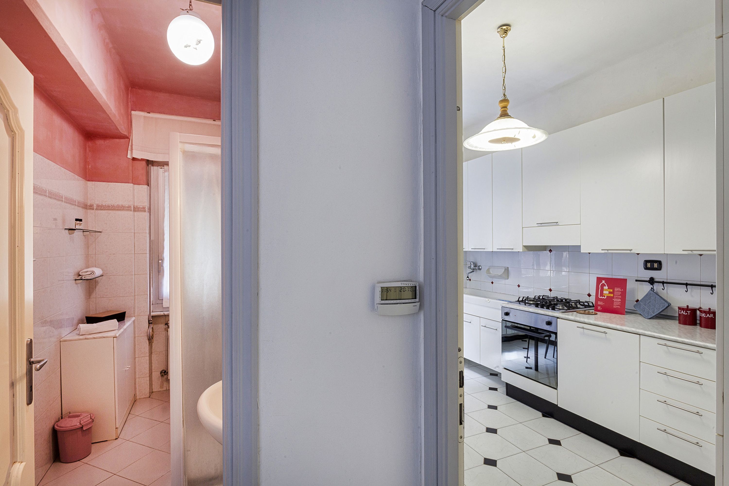A modern kitchen with white cabinets, a gas stove, and a built-in oven.