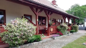 A traditional house with a stone pathway leading to a wooden porch.