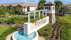 A pool area with a sign reading "Windsor at Wildwood." - Dreamy House  Pool at Windsor Westside Resort 9013 (Kissimmee)