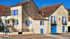A traditional European building with a stone facade, blue shutters, and a tiled roof. - Vacation home in the Ouche Valley Situated between Dijon and Beaune.  (La Bussière-sur-Ouche)