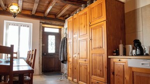 A wooden kitchen with cabinets, a dining table, and chairs. - Vacation home in the Ouche Valley Situated between Dijon and Beaune.  (La Bussière-sur-Ouche)