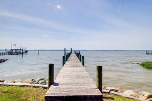 A wooden pier extending into calm water with a clear sky above. - Waterfront Gloucester Home w/ Private Boat Dock! (Gloucester)