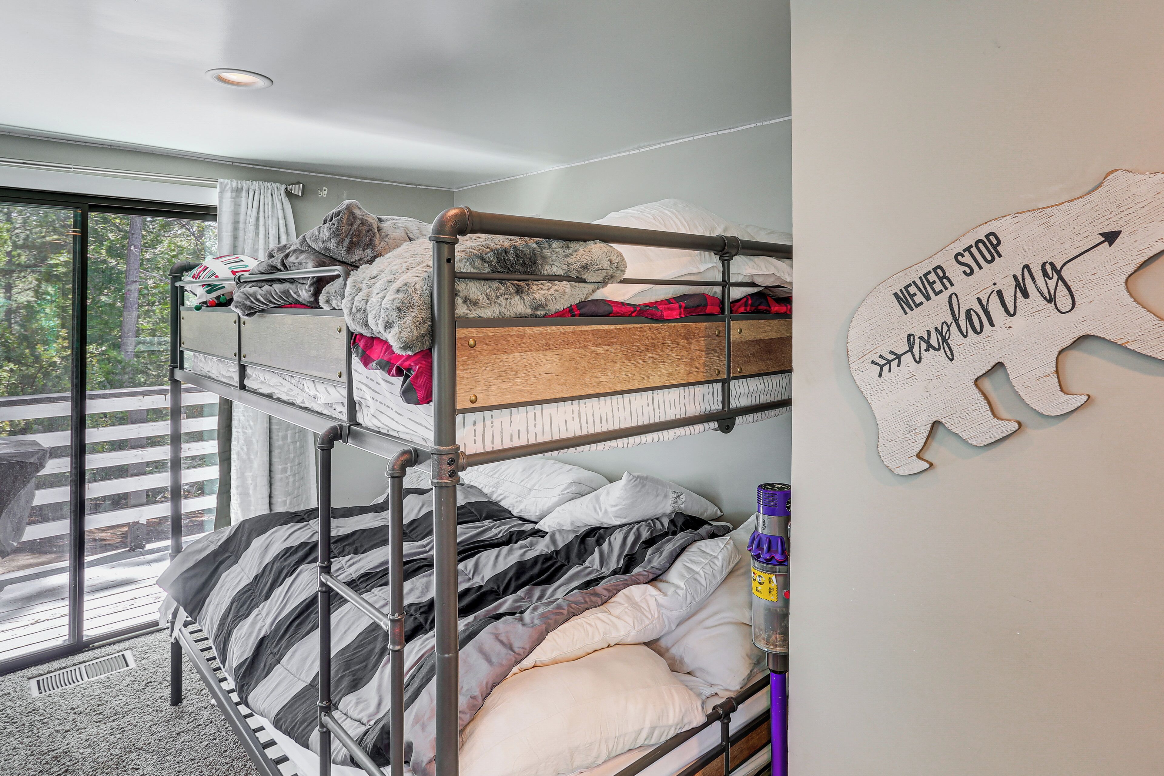 A bunk bed room with a view of the outdoors.