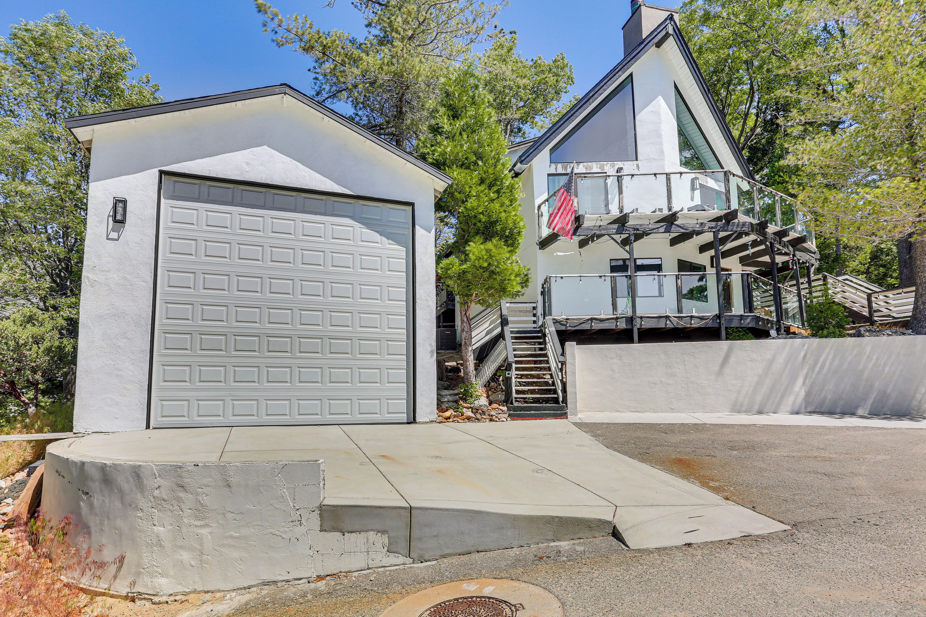 A two-story house with a garage, a staircase, and a small porch.