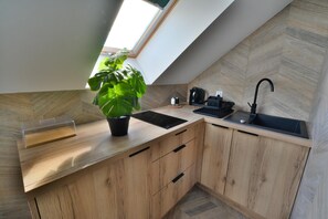 Fridge, stovetop, electric kettle, dining tables