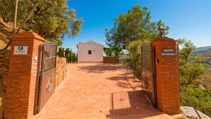 Un chemin pavé mène à un bâtiment blanc sur lequel on peut lire l’inscription « Villa Casillero ».