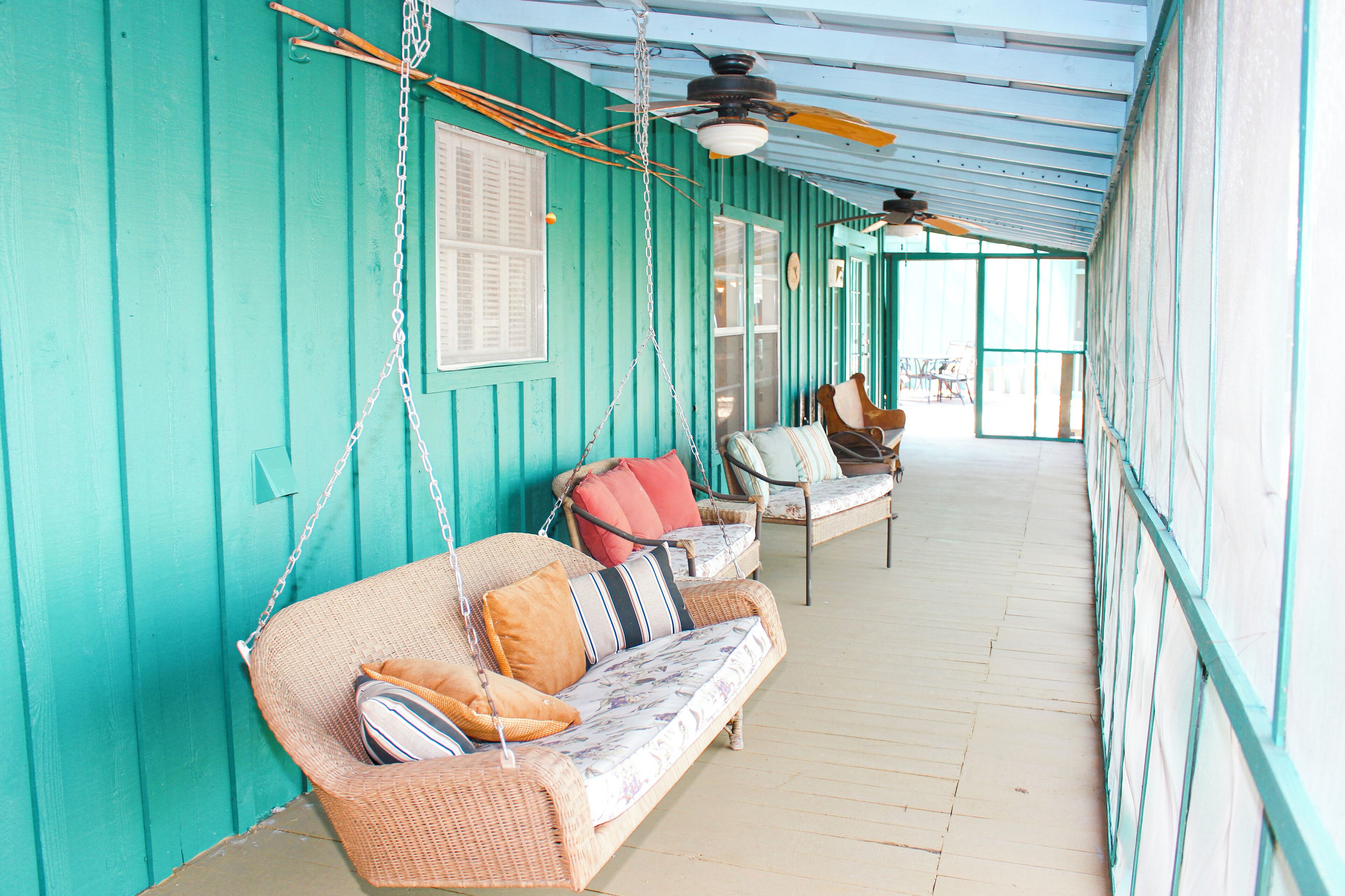 Small cabin screened-in porch with plenty of seating and lake views. 