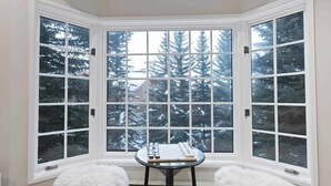A corner room with a bay window overlooking a snowy landscape. - The Charter at Beaver Creek E2405 (Beaver Creek)