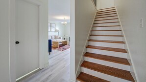 A staircase with wooden steps and a white wall.