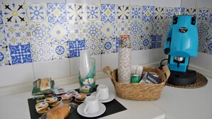 A kitchen counter with a coffee machine, a basket of plates, and various food items.