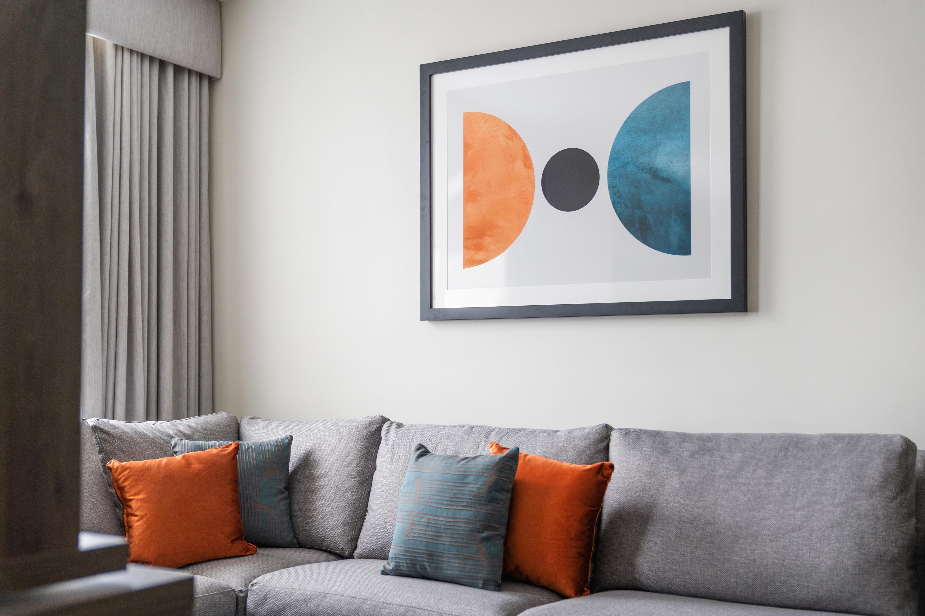 A grey sofa with multiple cushions in a modern living room.