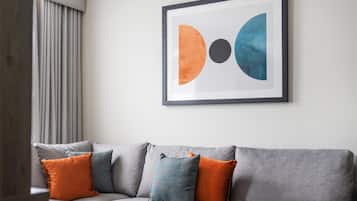A grey sofa with multiple cushions in a modern living room.