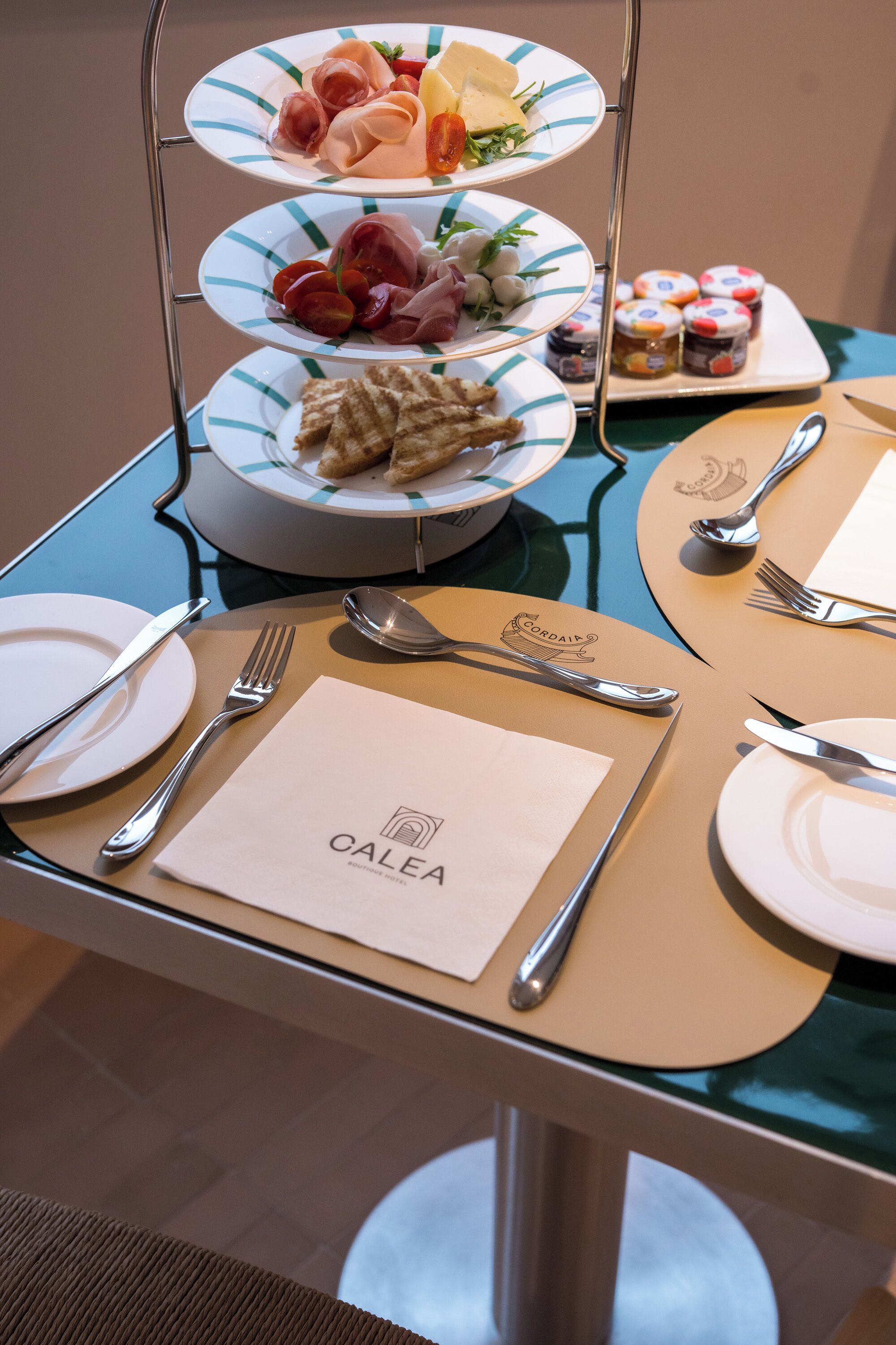 A dining table set with plates, cutlery, and a menu.